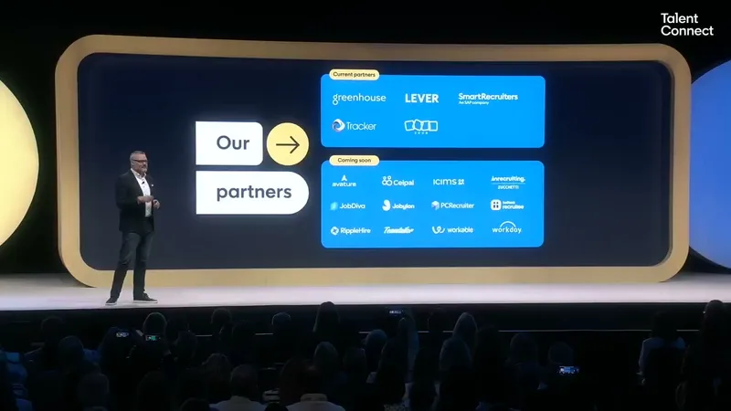 Dan Reid on stage in front of an Our partners slide with logos of current ATS partners including Greenhouse, Lever and SmartRecruiters and a list of partners marked coming soon